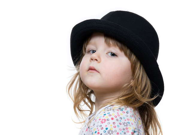 Cute little girl posing in black hat - Фото, изображение