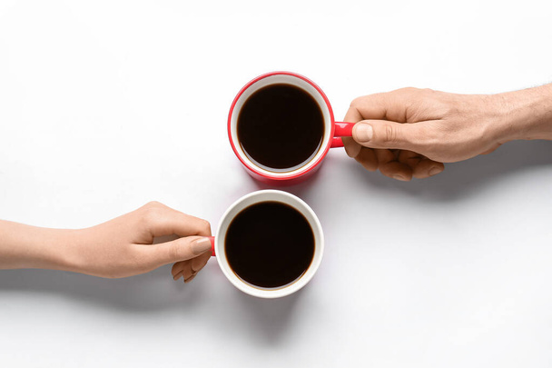 Woman and man with cups of coffee on white background - Photo, Image