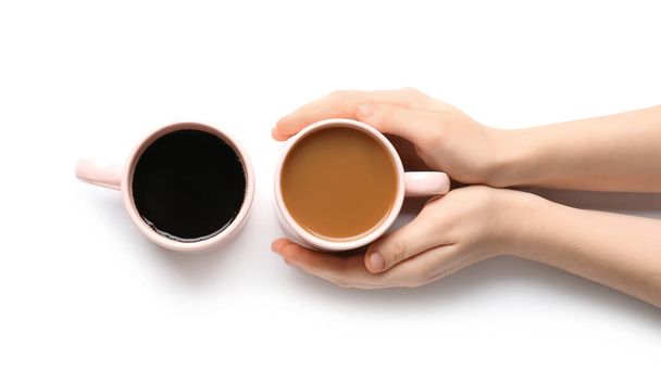 Female hands and cup of coffee on white background - Photo, Image