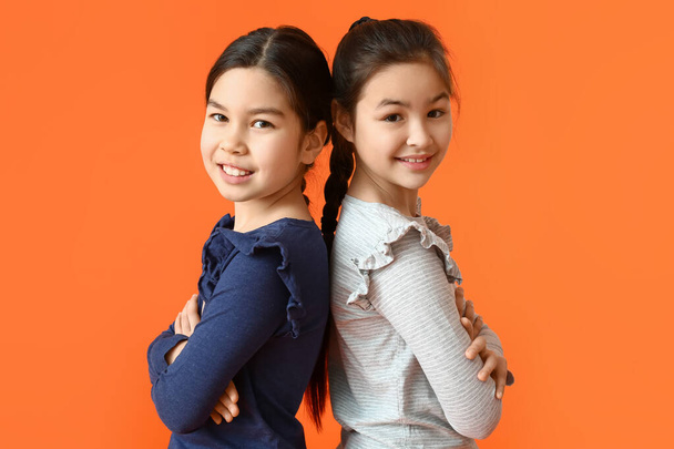 Cute little sisters on color background - Photo, Image
