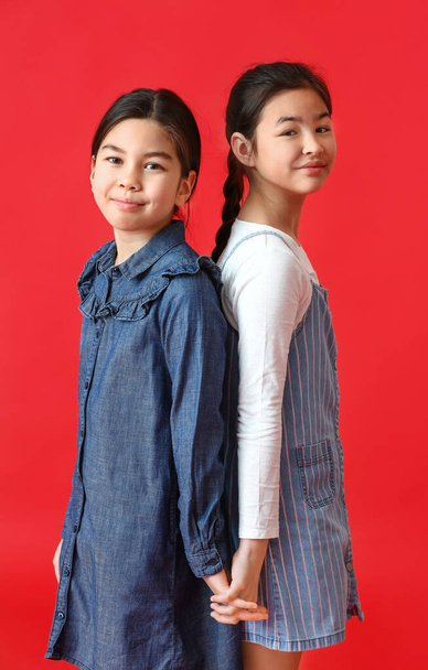 Cute little sisters on color background - Foto, Bild