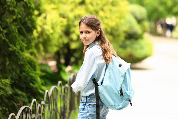 Little schoolgirl with backpack outdoors - Photo, Image
