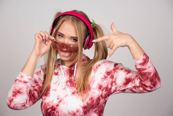 Blonde woman in pink glasses pointing at herself. High quality photo - Foto, afbeelding