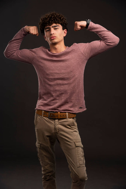 Junges Model im lässigen Herbst-Winter-Outfit zeigt seine Muskeln. Hochwertiges Foto - Foto, Bild