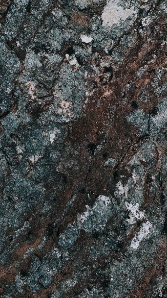 A vertical closeup shot of a stone textured surface - Фото, изображение