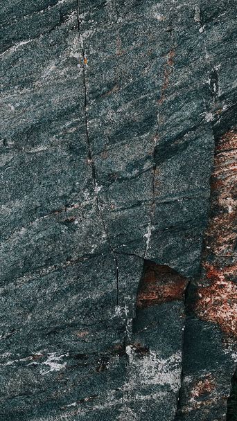 A vertical closeup shot of a stone textured surface - Foto, afbeelding