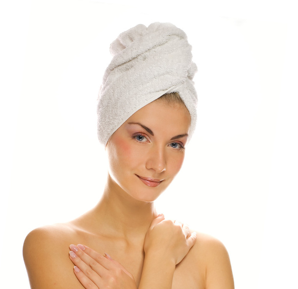 Beautiful woman with a white towel on her head isolated on white - Foto, immagini
