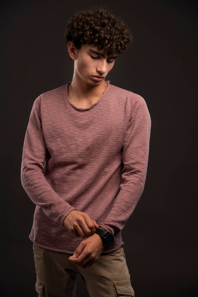 Young model in casual fall winter outfits promoting his watches. High quality photo - Photo, Image