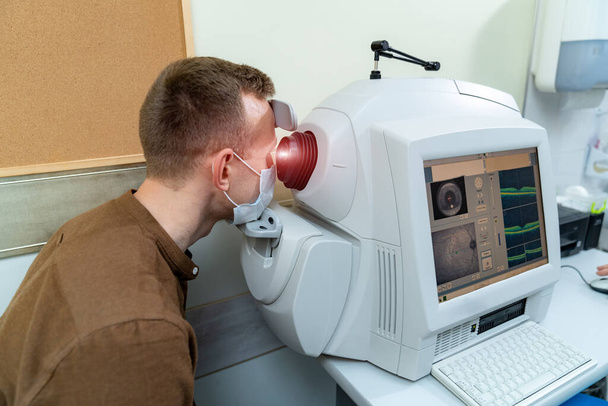 Professional eye diagnostic in modern hospital. Ophtalmology test equipment. - Фото, изображение