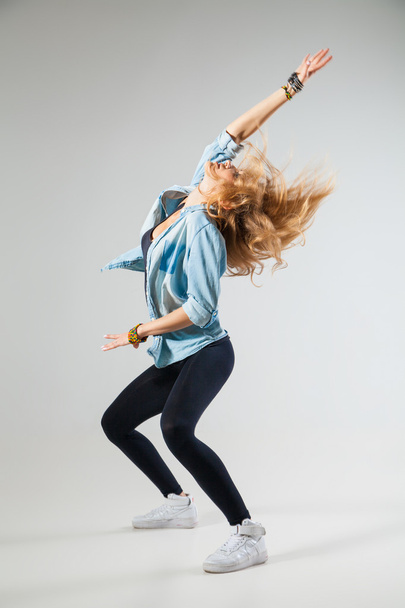 Modern dancer poses in front of studio background - Foto, Bild