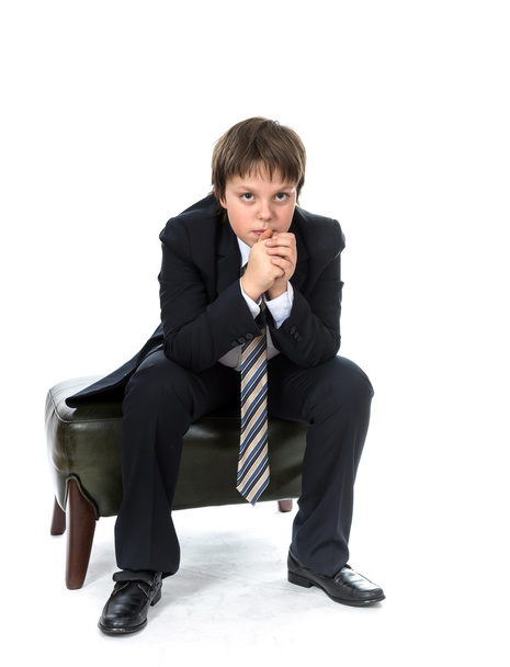 Young boy sitting on chair - Фото, изображение
