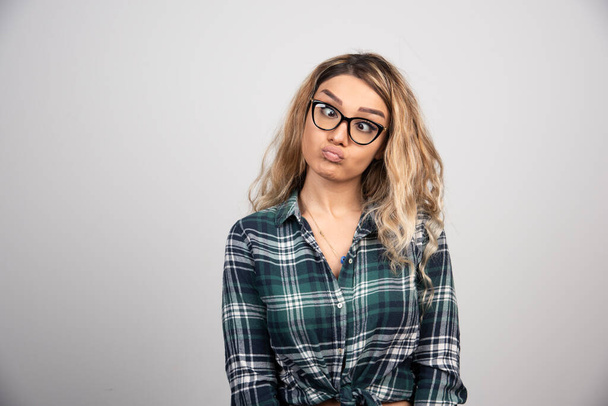 Portrait of woman in fashionable glasses making silly face. High quality photo - Photo, Image