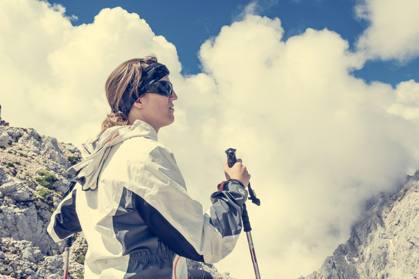Female looking at cloud covered mountains - Photo, Image