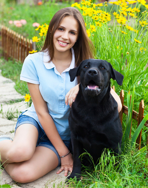 Dziewczyna nastolatka z czarnym labrador retriever  - Zdjęcie, obraz
