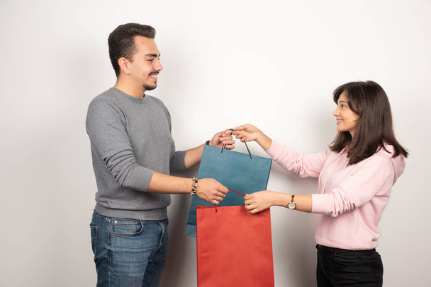 Young couple holding shopping bags together. High quality photo - Foto, immagini