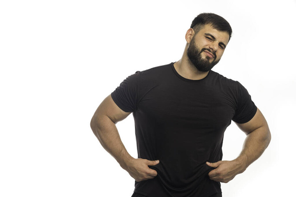 Sportovní muž v černé košili má nadváhu. Kvalitní fotografie - Fotografie, Obrázek