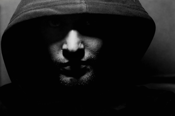 Monochrome picture of a guy in a hood - Photo, Image