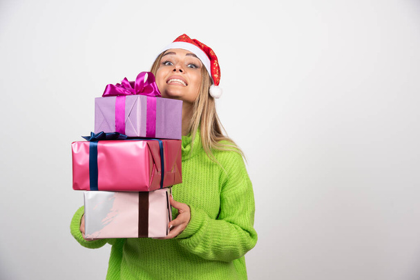 Young woman holding a lot of festive Christmas presents . High quality photo - Photo, Image