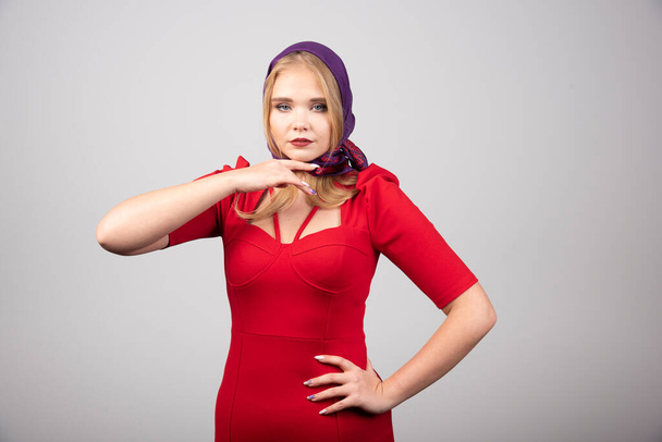 Young woman in red dress looking at camera. High quality photo - Valokuva, kuva