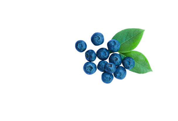 Pile of fresh blueberries with green leaves isolated on white background. - Photo, Image