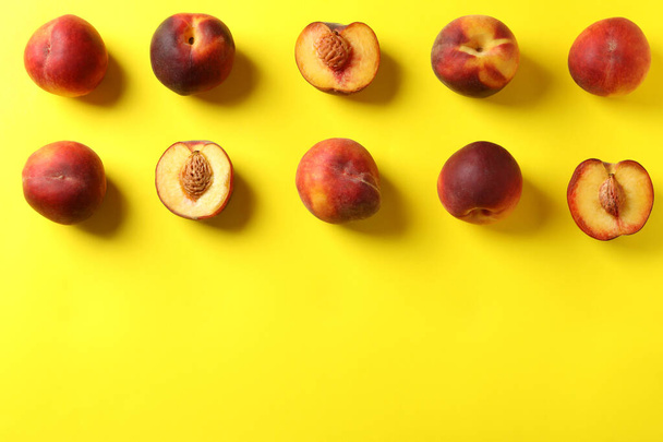 Fresh ripe peach fruits on yellow background - Photo, Image