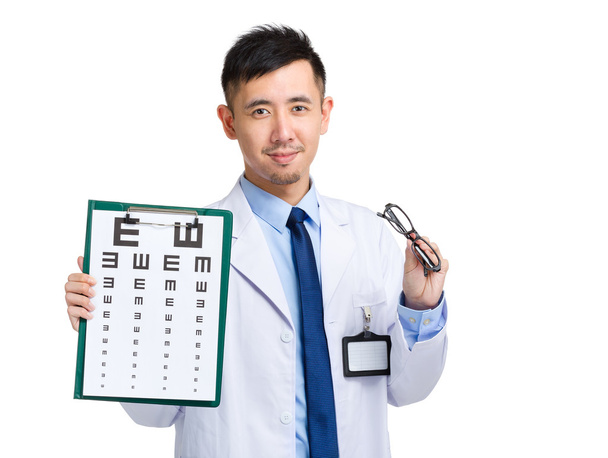 Oculist hold with eye chart and glasses - Photo, Image