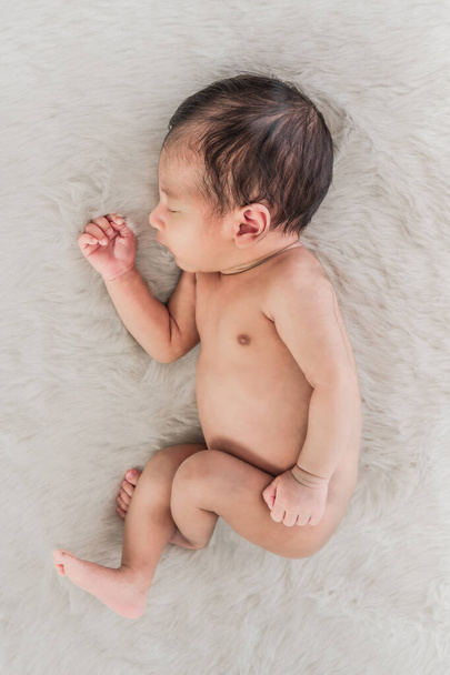 portrait of little newborn infant baby sleeping on white carpet - Foto, immagini