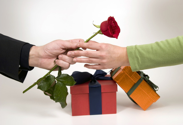 Man's hand gives rose and gift - Foto, imagen