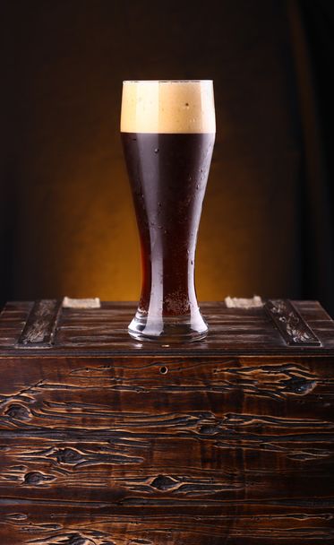 Glass of dark beer on a chest - Photo, Image
