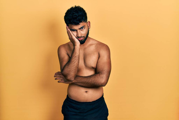 Arab man with beard wearing swimwear shirtless thinking looking tired and bored with depression problems with crossed arms.  - Foto, imagen