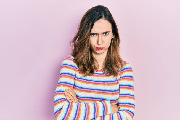 Young hispanic girl wearing casual clothes skeptic and nervous, disapproving expression on face with crossed arms. negative person.  - Photo, Image
