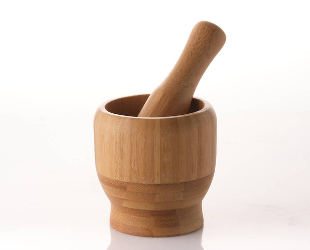 Wooden spice mortar with pestle on white background, isolated - Photo, Image