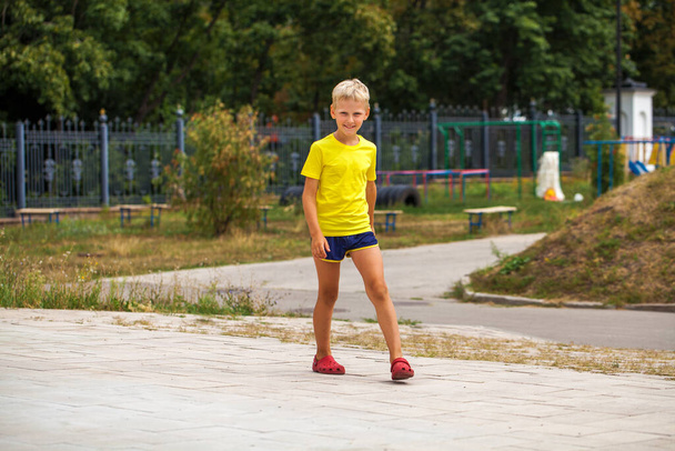 Close-up portrait of a little boy in a summer park - Fotoğraf, Görsel