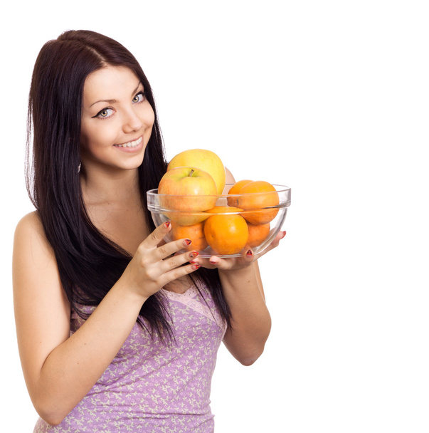 Happy woman holding a dish with fruits on white background - Photo, Image