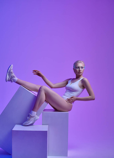 Model in futuristic glasses lying on cubes - Photo, Image