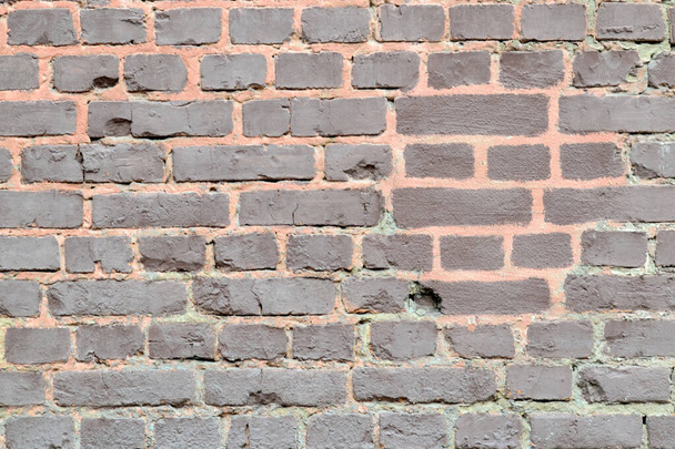 An old wall lined with bricks that have crumbled over time - Foto, Imagem