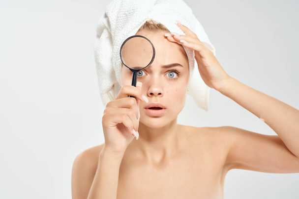surprised woman with bare shoulders clean skin magnifying glass in hands health problems - Photo, Image