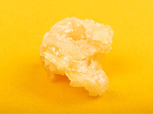 sugar cannabis wax concentrate close up on yellow background - Foto, imagen