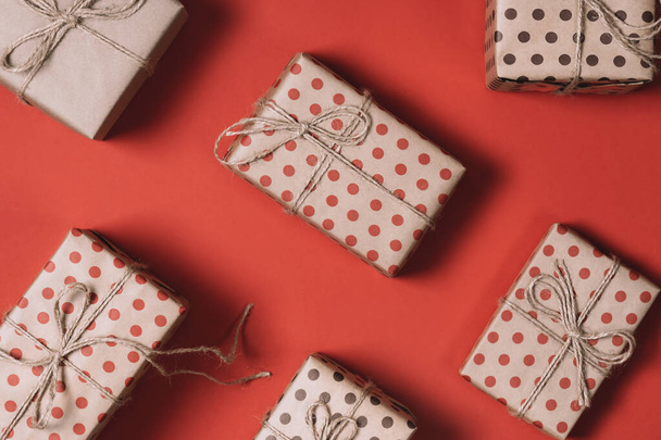 Top view of many Christmas gifts on a red background with copy space. - Photo, image