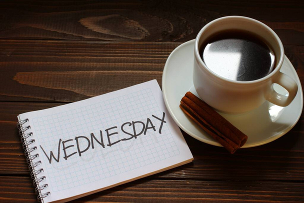 Inscripción del miércoles y palabra en un cuaderno cerca de una taza de café - Foto, Imagen