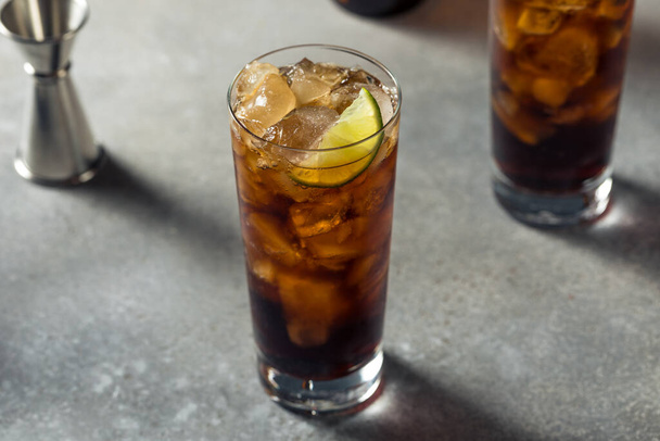 Boozy Refreshing Amaro and Cola Cocktail with Lime - Фото, изображение