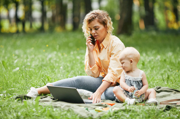 Mother Working Remote in Park - Photo, Image