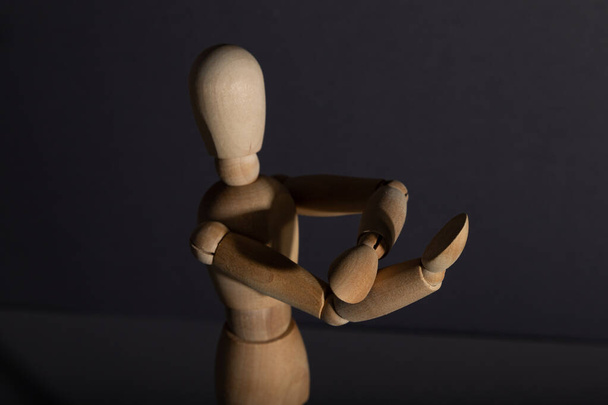 Wooden mannequin shows obscene gesture fuck off with hands on gray background. protest, riot, agression, contempt concept. copy space, hard light. - Φωτογραφία, εικόνα