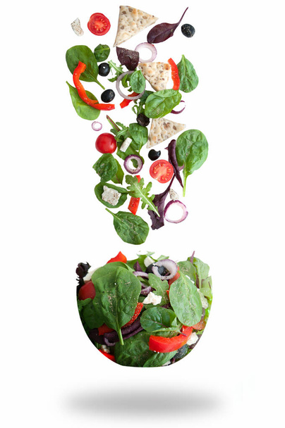 Fresh salad ingredients in a bowl shape hovering in mid air - Photo, Image