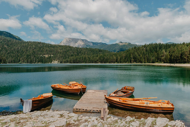 Boats on Black Lake - Crno jezero , northern Montenegro. It is a glacial lakeon the Mount Durmitor, on an altitude of 1,416 m. Black lake in Durmitor national park in Montenegro, Europe. Beauty world. - 写真・画像
