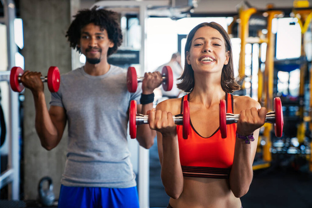 Picture of cheerful happy fitness team exercise together in gym - Fotoğraf, Görsel