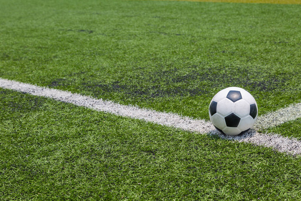 soccer ball on the white line on green soccer field grass background - Photo, Image