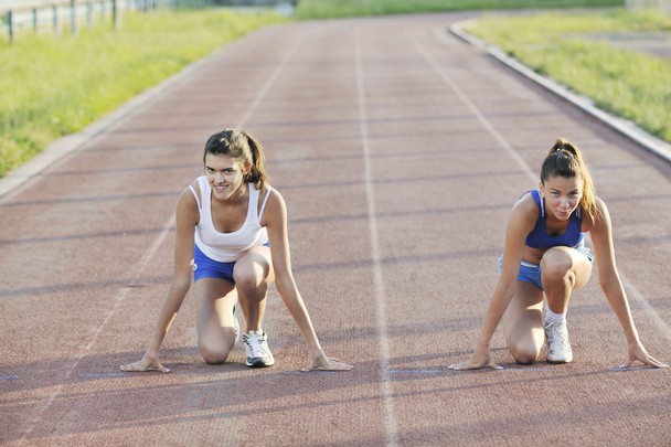 Young girl morning run and competition on athletic race track - Foto, Imagem
