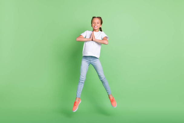 Full length body size photo little girl jumping up asking wish isolated pastel green color background - Foto, Imagem