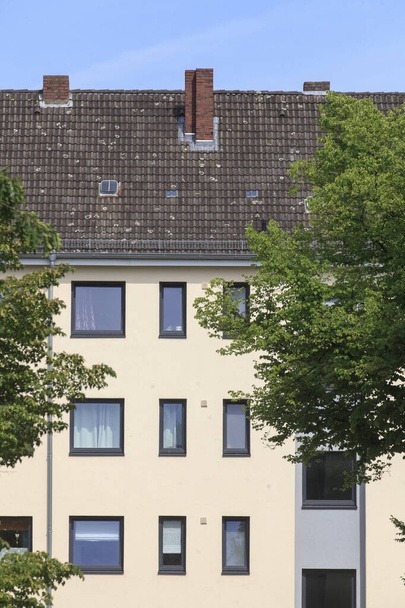 A vertical shot of a residential building on a sunny day in Bremerhaven in Germany - 写真・画像